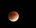 During a lunar eclipse, the Moon is colored red by indirect sunlight, which Earth's atmosphere has scattered and refracted.