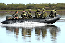 Marines on patrol boat for river