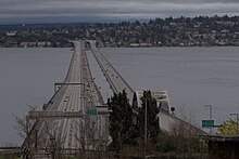 Two of five lanes of the westbound I-90 floating bridge are closed to traffic and filled with runners.