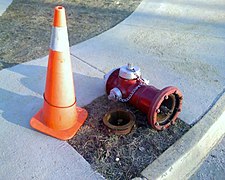 A fire hydrant that was hit by a snow plow and knocked over, damaging only the sacrificial bolts