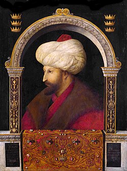 Portrait bust of a middle-ages bearded man, wearing a large turban and fur-trimmed clothing, enclosed within a richly decorated arch
