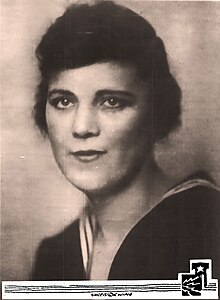 A young white woman with short hair, wearing a US Coast Guard Uniform, from a 1918 photograph.