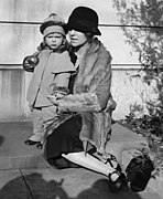 Two-year-old Paulina with her mother, Alice Roosevelt Longworth, wearing a winter costume of coat and trousers, 1927.