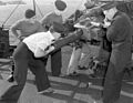 British sailors loading a QF 4 inch Mk IV gun in 1942