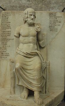 Statue of Euripides in front of titles of his works