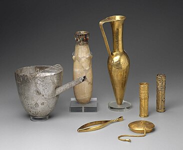 Artifacts including large metal tweezers, decorated and inscribed vessels, gold sheaths, and a ewer marked for King Aspelta found in Nuri pyramid 8. Museum of Fine Arts, Boston.