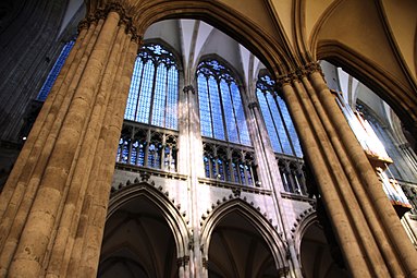 Triforium in Cologne Cathedral (Gothic Revival). The outer wall of this triforium contains large stained-glass windows.