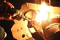 Fire starting with a torch. Wood and cardboard are used as tinder