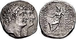 Coin minted by Antiochus XI and Philip I. The obverse depict them together with Antiochus XI appearing ahead of Philip. The reverse contain the kings' names to the right and their epithets to the left. In the middle of the reverse, Zeus is depicted sitting on a throne holding a sceptre and holding a Nike in his hand which is stretched toward the inscription of the epithets.