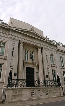 Photograph of a building in grey stone with columns.