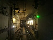 View of the underground tunnel with the overhead lines powering the train