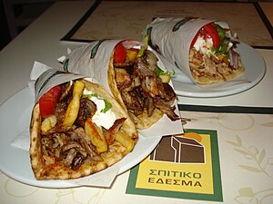 Gyros are a Greek dish of meat cooked on a vertical rotisserie.