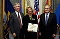 Secretary of Defense Donald H. Rumsfeld presents Kristin Devold with the medal.