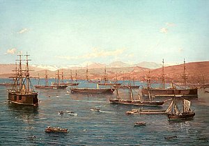 Painting of numerous ships in front of a bay.