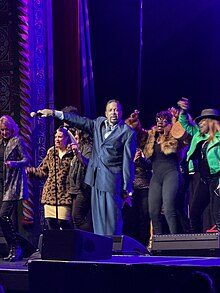 Morris Day on stage with fans, in 2024