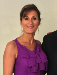 Nathalie Palladitcheff wearing a sleeveless ruffled purple dress.