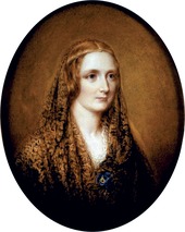 Black-and-white oval portrait of a woman wearing a shawl and a thin circlet around her head.