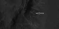 Close view of ridges from previous HiRISE image. Arrow indicates an X-shaped ridge.