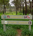 Old CALM sign with various labels, marsh area of south west corner in background