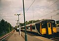 A WAGN EMU travels trough Harlow station in 2001.