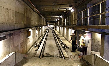 View of a track from a sand drag, in the Montreal Metro near the Beaugrand Station, showing the cross-section of guide bars, precast concrete roll ways and conventional track