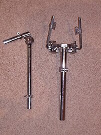 Tom arms with memory: a standard 7/8" arm (left) and a Tama twin speedball bracket (right)