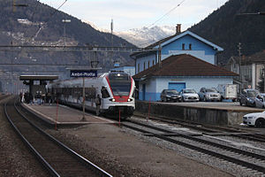 Red-and-white train at island platform