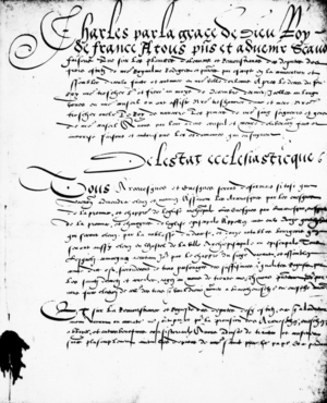 Front page of the Edict of Saint Germain, with flowing french writing on it.