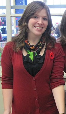 Kate Beaton at NEWW, wearing a Remembrance Poppy