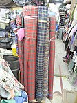 Tartan and other textiles for sale in bulk at Yen Chow Street Hawker Bazaar, Hong Kong, 2022