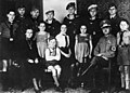 13.8.1943, The political Nazi leader Reichel (from Erdmannsdorf in Saxony) with his wife and twelve children all dressed in Nazi Party or military uniforms. The mother is decorated with the Cross of Honor of the German Mother.Five sons are with the German Wehrmacht; the sixth is with the Reich Labor Service. The smaller children are all members of Nazi youth organizations. The youngest girls have Wolfsangel symbols on their dresses; a sign for members in NS-Frauenschaft's Deutsche Kinderschar for children aged between 6 and 10. Photo: Bundesarchiv (German Federal Archives)