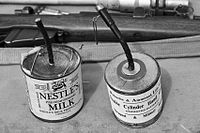 Trench improvised explosive device in a milk tin and a similar manufactured double cylinder grenade (A Great War Society munition)