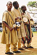 Yoruba drummers: One holds omele ako and batá, the other two hold dunduns.