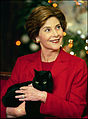 Laura Bush holding their family cat India, a solid black American Shorthair (2004)