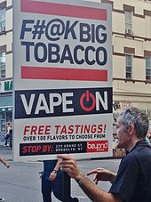 E-cigarette retailer marketing sign in Williamsburg, Brooklyn, New York, United States. The sign states, "F#@K Big Tobacco, vape on, and free tastings".