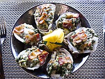 Oysters Rockefeller topped with bacon