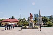 skrima practitioners stand at attention in front of the Lapu-Lapu Monument. Photo by Budots Media / Bart Sakwerda, 2022.