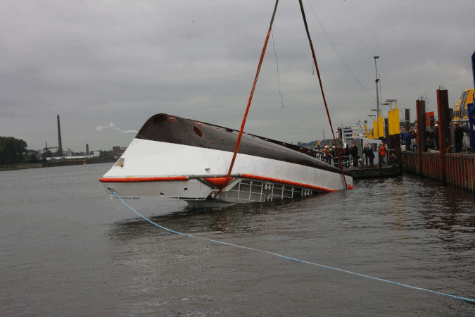A larger self-righting vessel's stability test. Note large deckhouse, which is almost the only part submerged when fully inverted.