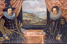 A man and a woman standing at a table near a window