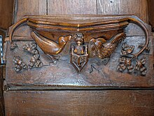 Misericord with a carved scene showing a fox preaching from a pulpit to a cockerel and a goose.