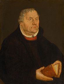A painting of Protestant Reformer Martin Luther, wearing a black gown and white collar, holding a Bible.