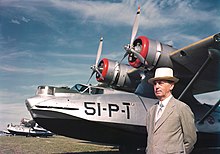 In suit, standing in front of a line of PBY Catalina seaplanes of patrol squadron VP-51