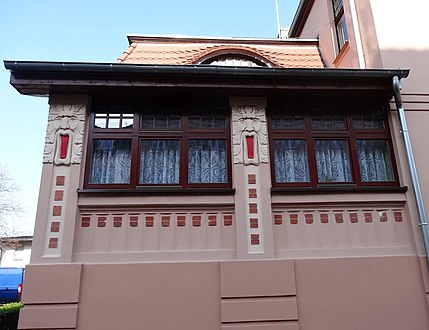 Detail of the masks flanking the windows