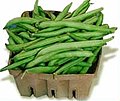 Whole raw green beans packed in a punnet for sale
