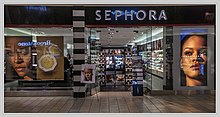 A Sephora storefront with large posters showing two close-up photos of Rihanna and one Fenty Beauty cosmetic item