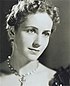 Promotional photograph of Peggy Ashcroft for Rhodes. She is looking to the right and wearing a necklace