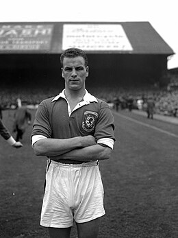 John Charles in uniform on the pitch, with arms folded