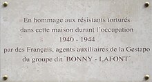 Commemorative plaque with the inscription "In hommage to Resistance members tortured in this house during the occupation 1940-1944, by French agents of the Gestapo from the group known as "Bonny-Lafont"