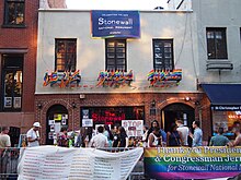 A color photograph of the Stonewall Inn taken in 2016, showing a smaller plate glass window in a portion of the 1969 building