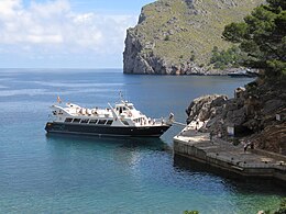 Tourist boat loading passengers at a small quay, Sa Calobra, Majorca, Spain